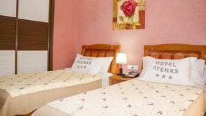 A hotel room with two beds, each with a pillow labeled "HOTEL ATENAS". - Atenas Hotel (Tetouan)