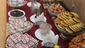 A buffet table with various food items and condiments. - Atenas Hotel (Tetouan)