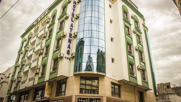 A hotel with a modern glass facade and traditional architecture. - Atenas Hotel (Tetouan)