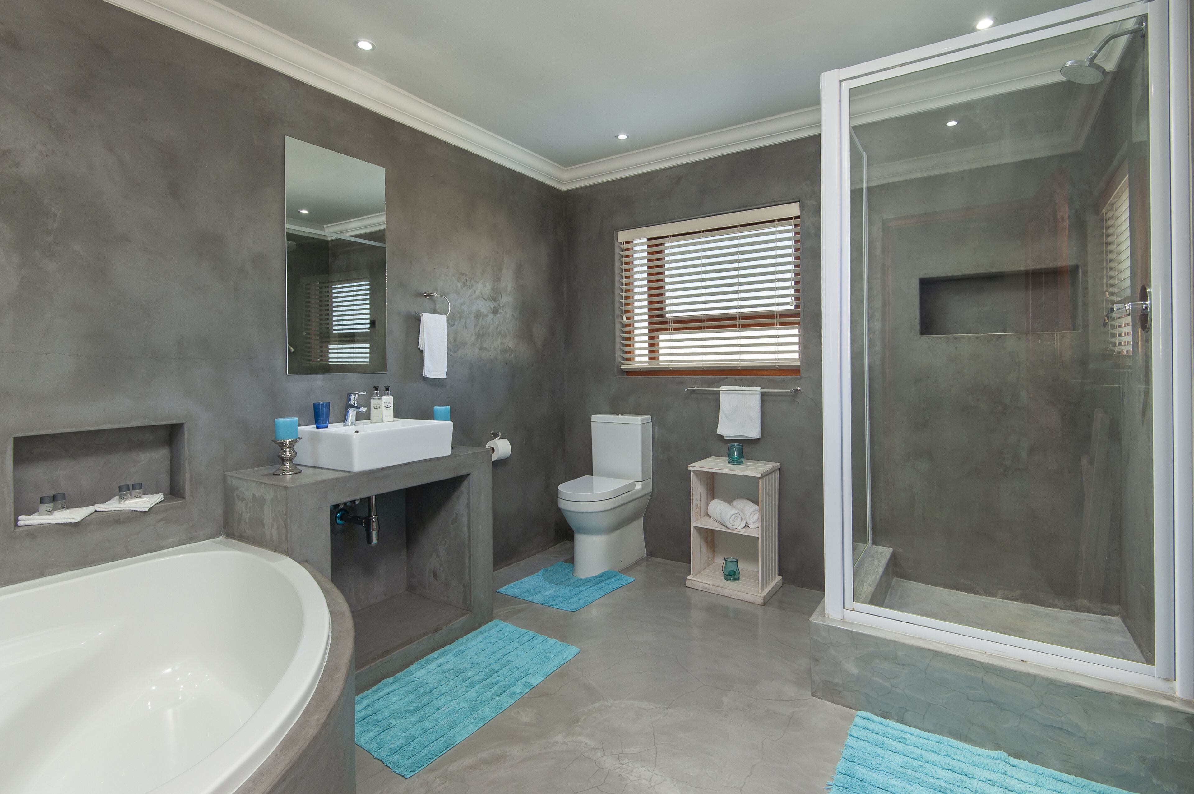 A modern bathroom with a bathtub, toilet, and walk-in shower.