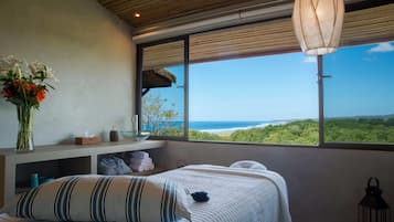 Enjoy a restful night's sleep in this serene room with a large bed and stunning ocean views.