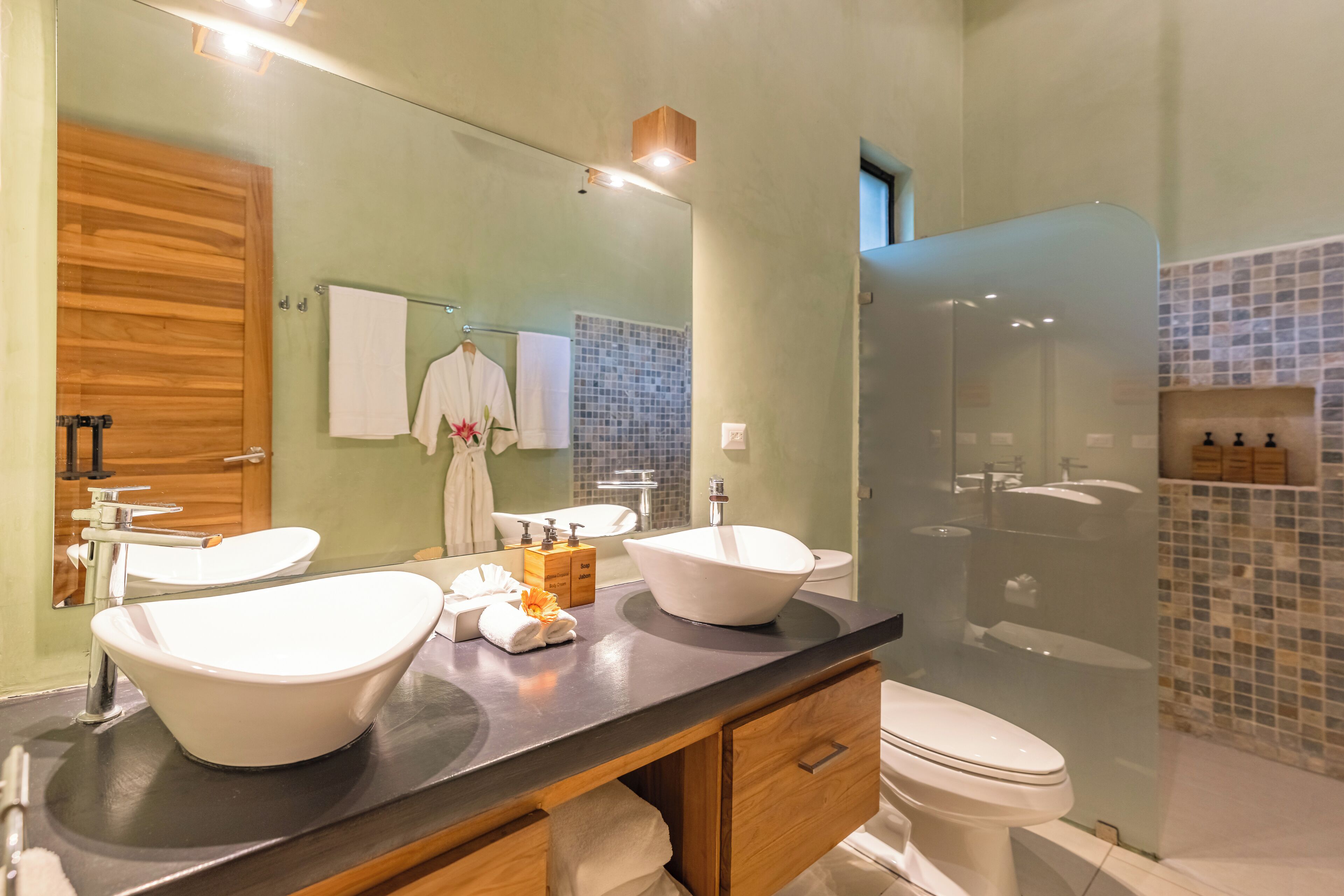 suite (flor blanca, one king bed) | bathroom | shower, rainfall showerhead, eco-friendly toiletries, hair dryer