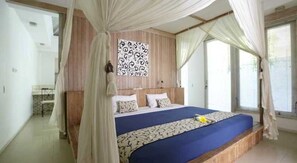 A bedroom with a canopy bed, wooden paneling, a patterned wall hanging, and a view of the outdoors. - Artemis Villa (Seminyak)