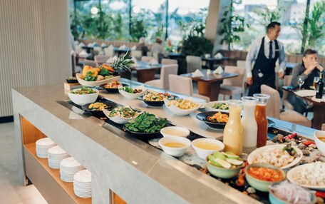 A buffet setup with various dishes and beverages.