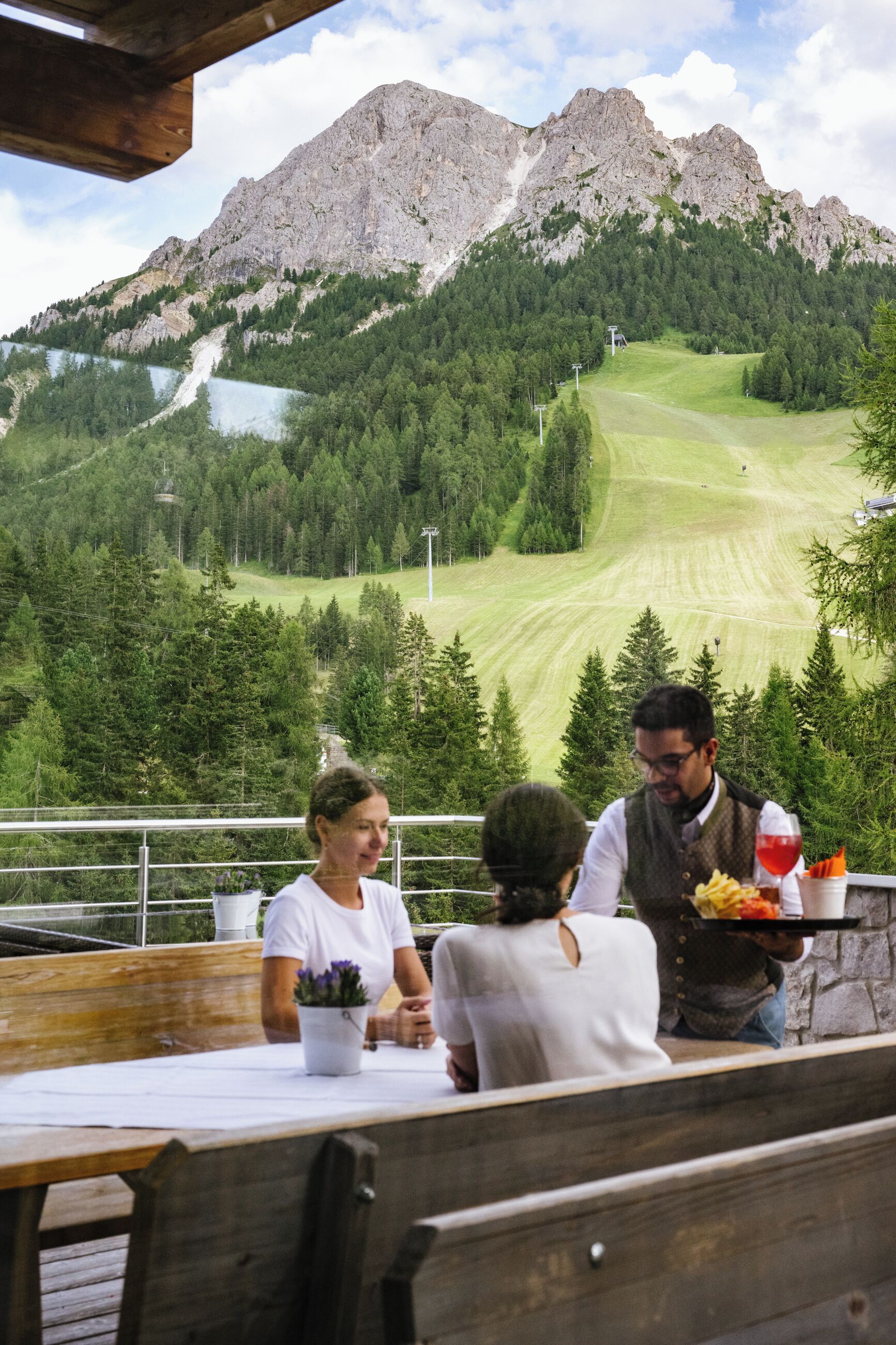 A restaurant with a view of a mountain and a lake.