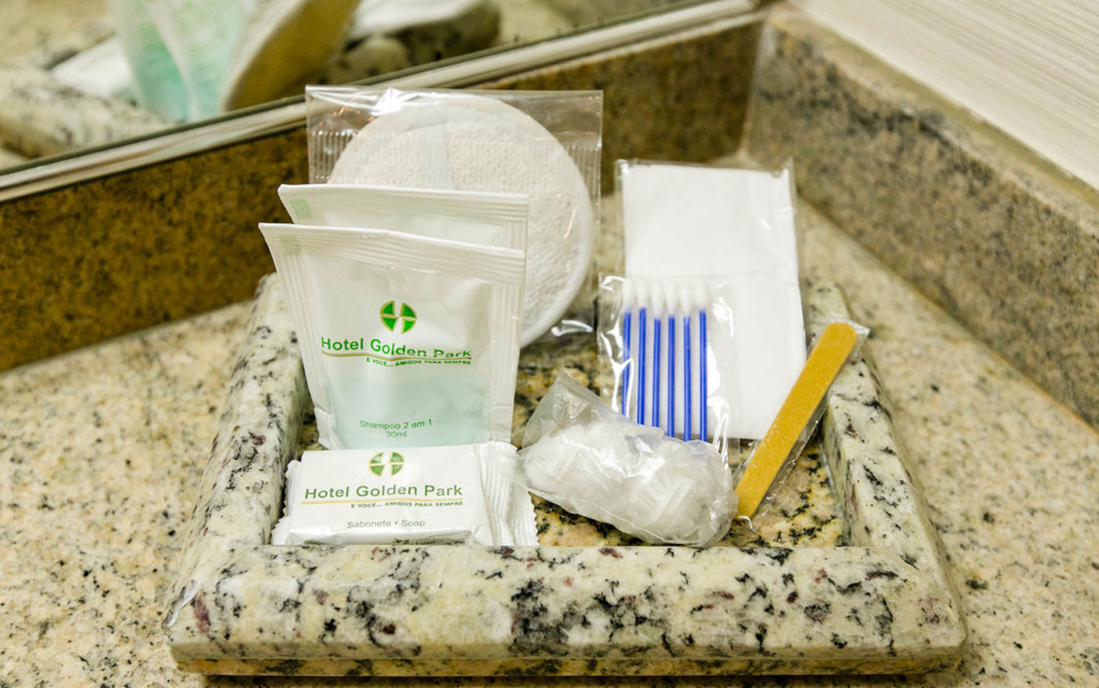 A tray with toiletries including shampoo, soap, and toothbrushes.
