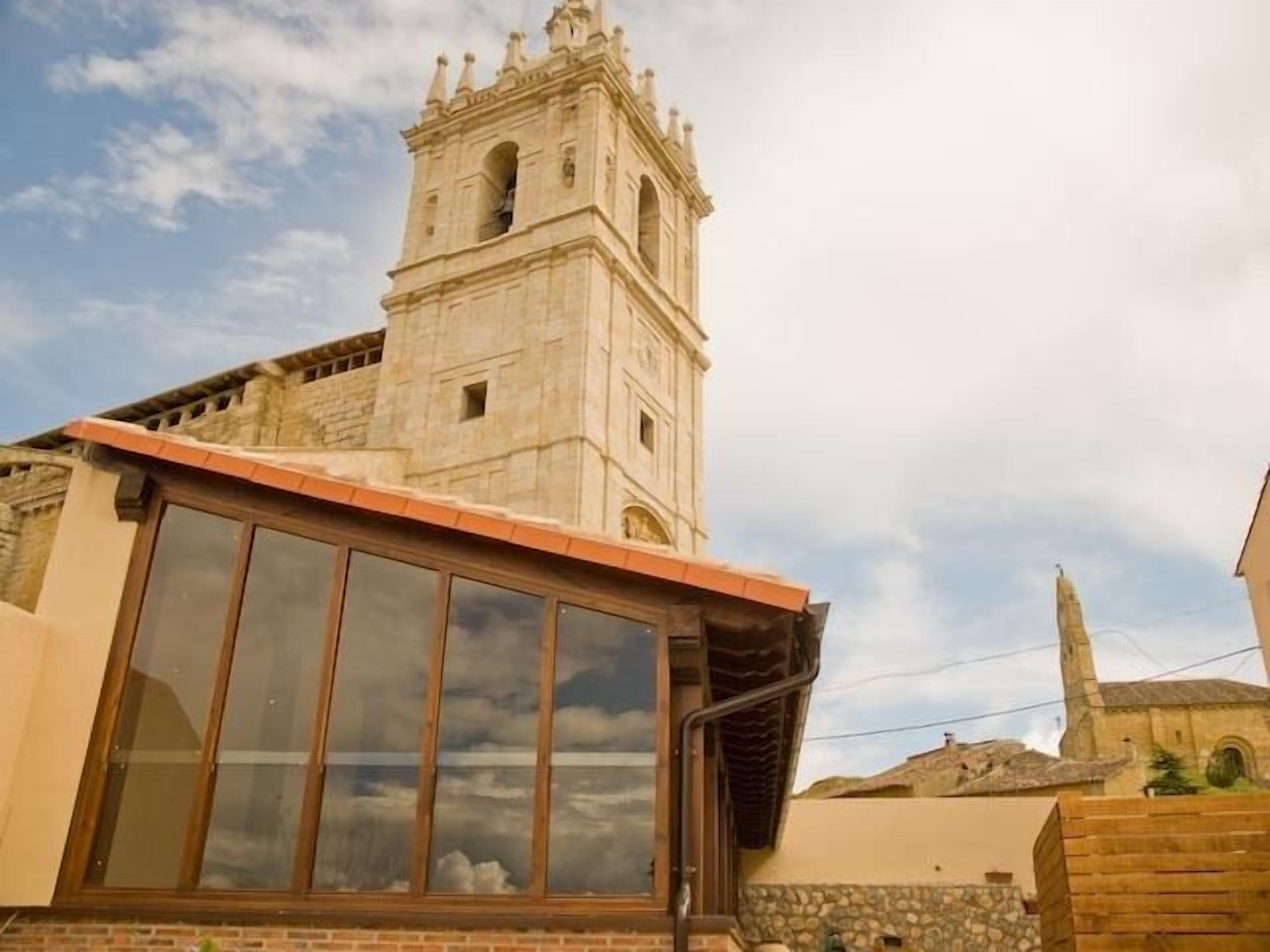A building with a prominent tower and a large window.