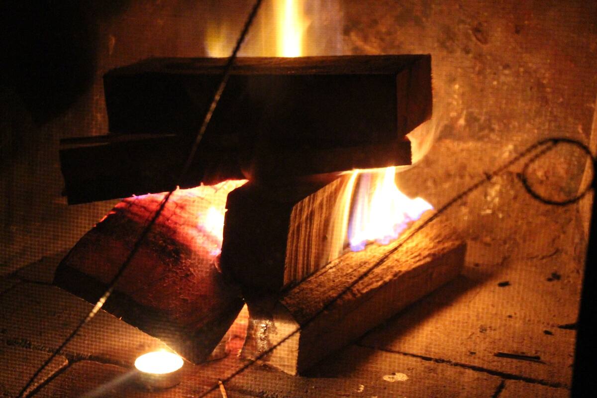 A close-up of a metal object being heated in a forge.