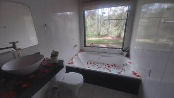 A bathroom with a bathtub, sink, and toilet.