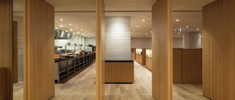 A modern interior with wooden paneling, a central island, and a kitchen area with appliances and counter space.