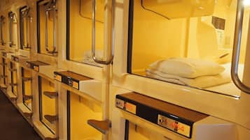 A row of bunk beds with metal railings and numbered compartments.