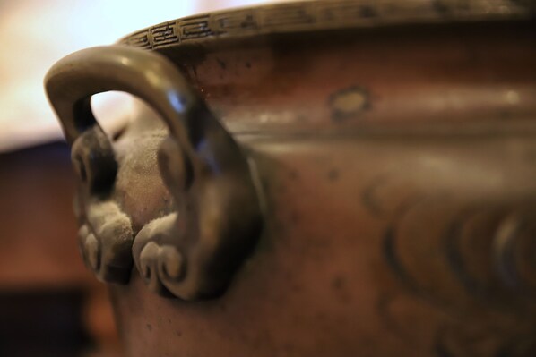 A close-up of a ceramic pot with a handle and decorative patterns. - Daikokuya Ryokan (Hakodate)