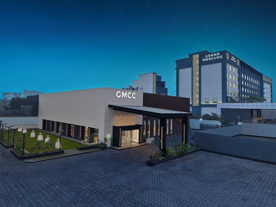 A modern building with a sign reading "GMCC" and "Grand Mercury" on the facade.