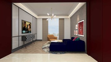 A modern living room with a large flat-screen TV, a sofa, a chair, and a patterned rug.