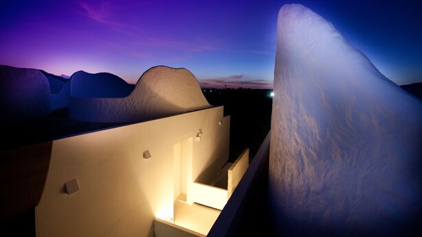A modern building with a unique architectural design featuring large ice-like structures. - Ohana Resort and Restaurant (Rayong)
