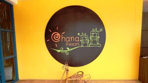 A logo for "Chana Resort" with a stylized sun and buildings, and a rustic rocking chair in front. - Ohana Resort and Restaurant (Rayong)