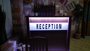 A reception desk with a sign that reads "RECEPTION".