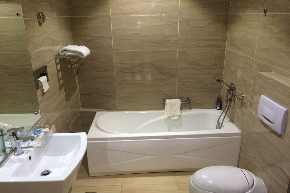 A bathroom with a bathtub, a sink, and a toilet.
