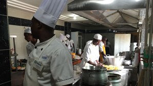 A professional kitchen with chefs preparing food. - Sun Beach Hotel (Cotonou)