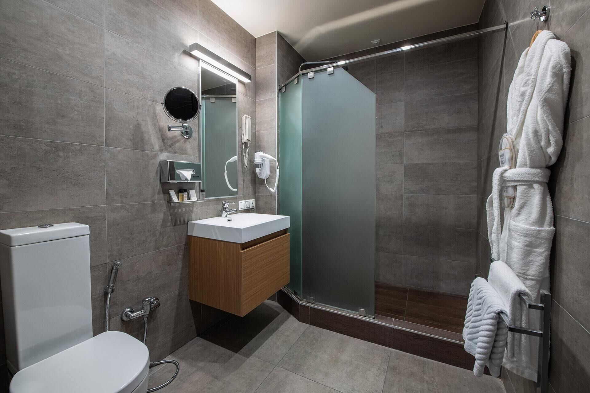 designer toiletries, hair dryer, slippers, bidet