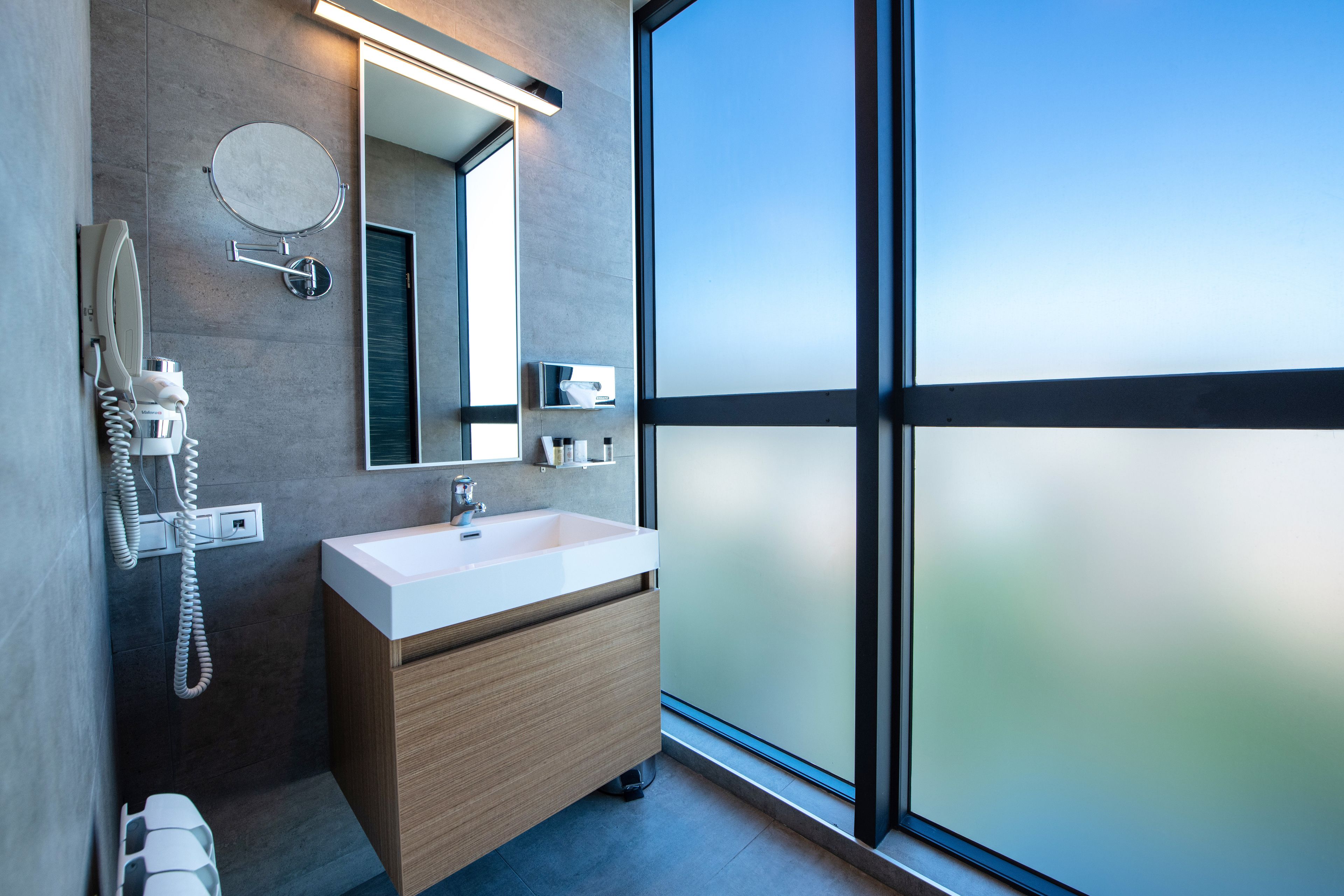 designer toiletries, hair dryer, slippers, bidet