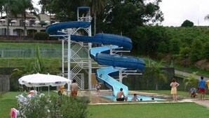 A water park with multiple slides and a pool area. - Hotel Fazenda São Matheus (Serra Negra)