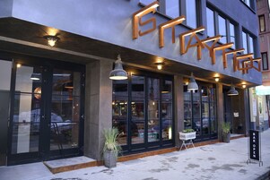 A modern building with large windows and a sign that reads "STAY HERE".