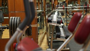 A gym with weightlifting equipment, including barbells and a bench. - Helnan Landmark Hotel (New Cairo)