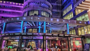 Helnan Landmark New Cairo's exterior with a prominent sign, a covered entrance area, and outdoor seating. - Helnan Landmark Hotel (New Cairo)
