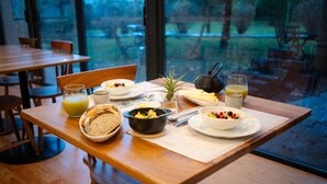 A breakfast table with various dishes, a teapot, and a glass of orange juice. -  Carmo Country Villas (Ponta Delgada)