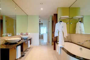 Executive suite | Badkamer | Een aparte badkuip en douche, een regendouche, gratis toiletartikelen