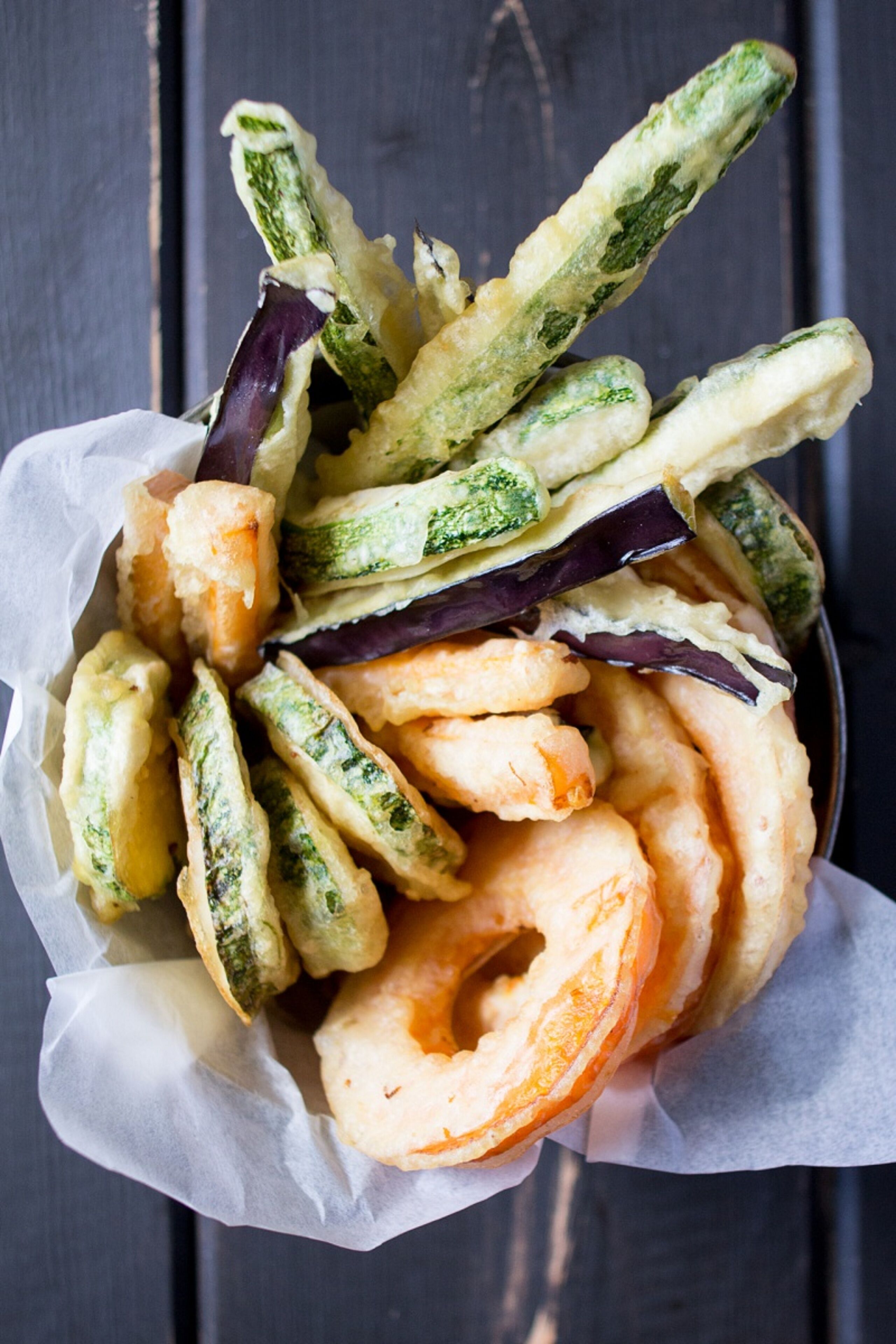 A basket of fried zucchini and eggplant slices.