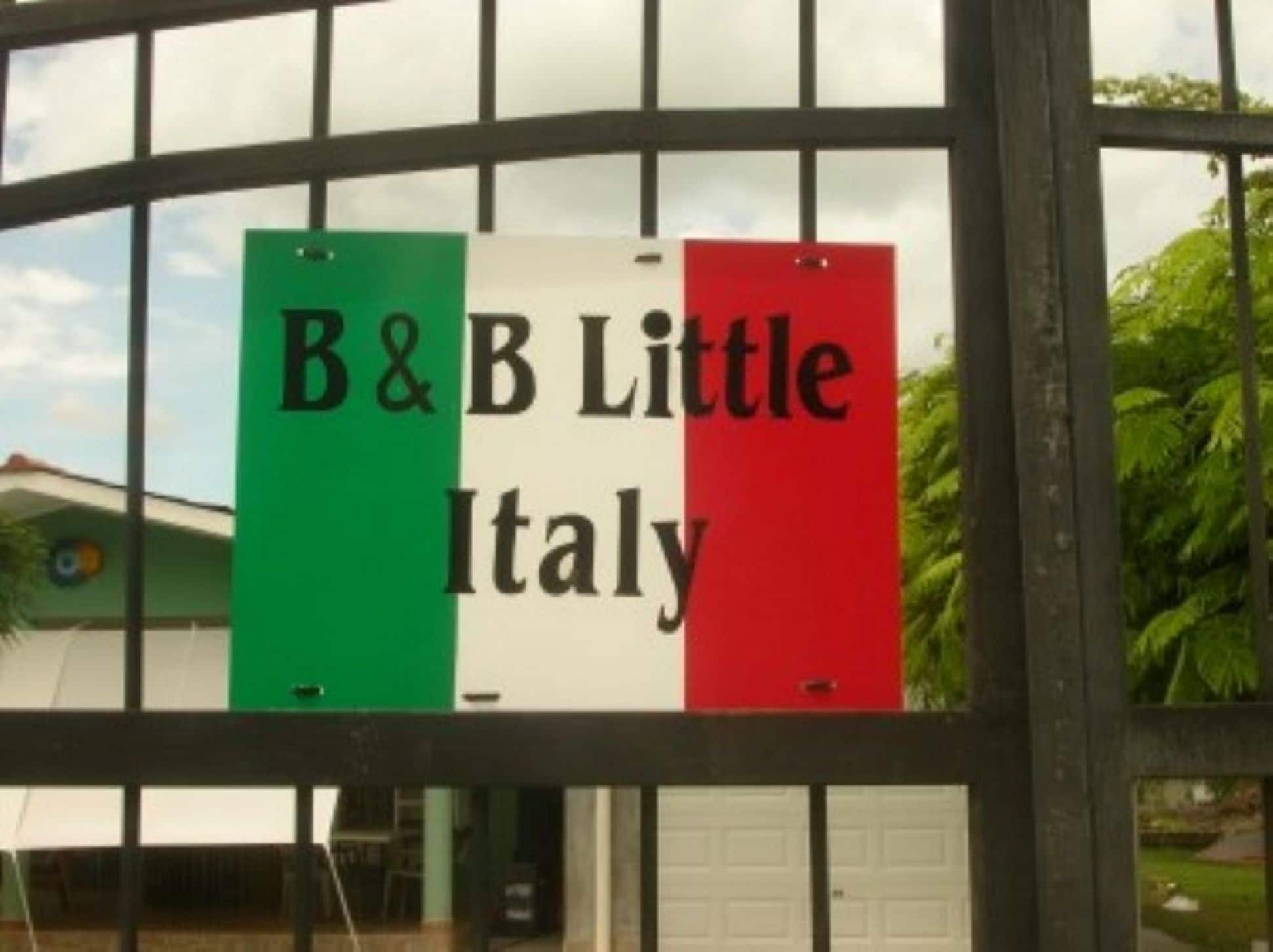 A sign with the text "B&B Little Italy" on a building facade.