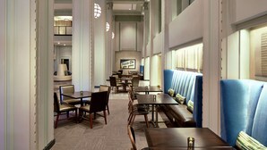 A restaurant with booths and tables, a sign reading "Produce COF", and a high ceiling with decorative lighting. - Hilton Garden Inn Phoenix Downtown (Phoenix)