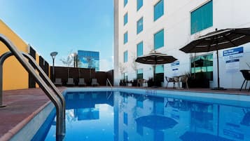 Outdoor pool, open 9:00 AM to 9:00 PM, pool umbrellas