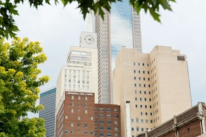 Classic hotel with a clock tower, situated in a bustling urban area.