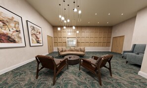 A spacious room with a large sofa, two armchairs, a coffee table, and a blue armchair. There are two framed artworks on the wall, a wooden panel wall, and a ceiling with hanging lights. - Hampton Inn & Suites Dallas Downtown (Dallas)