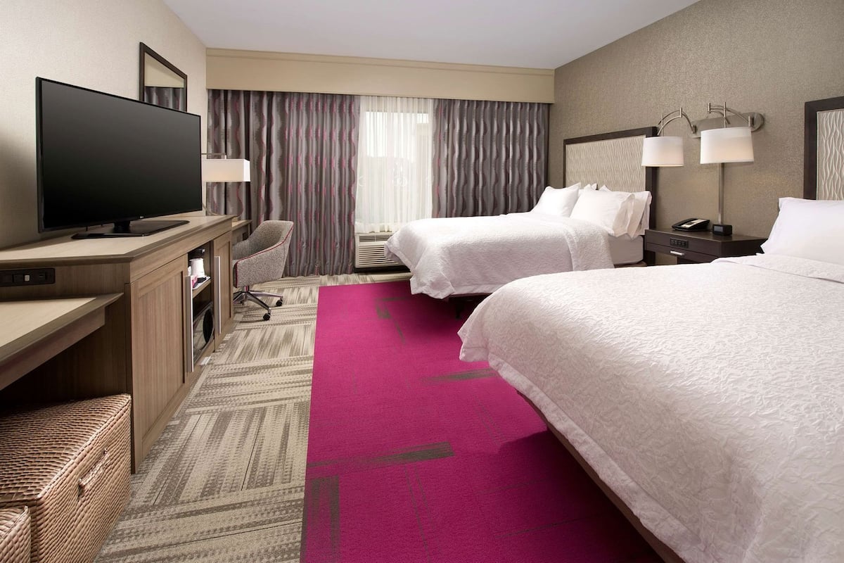 Premium bedding, desk, laptop workspace, blackout drapes