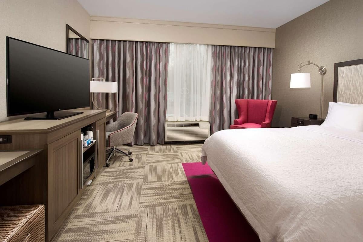 Premium bedding, desk, laptop workspace, blackout drapes