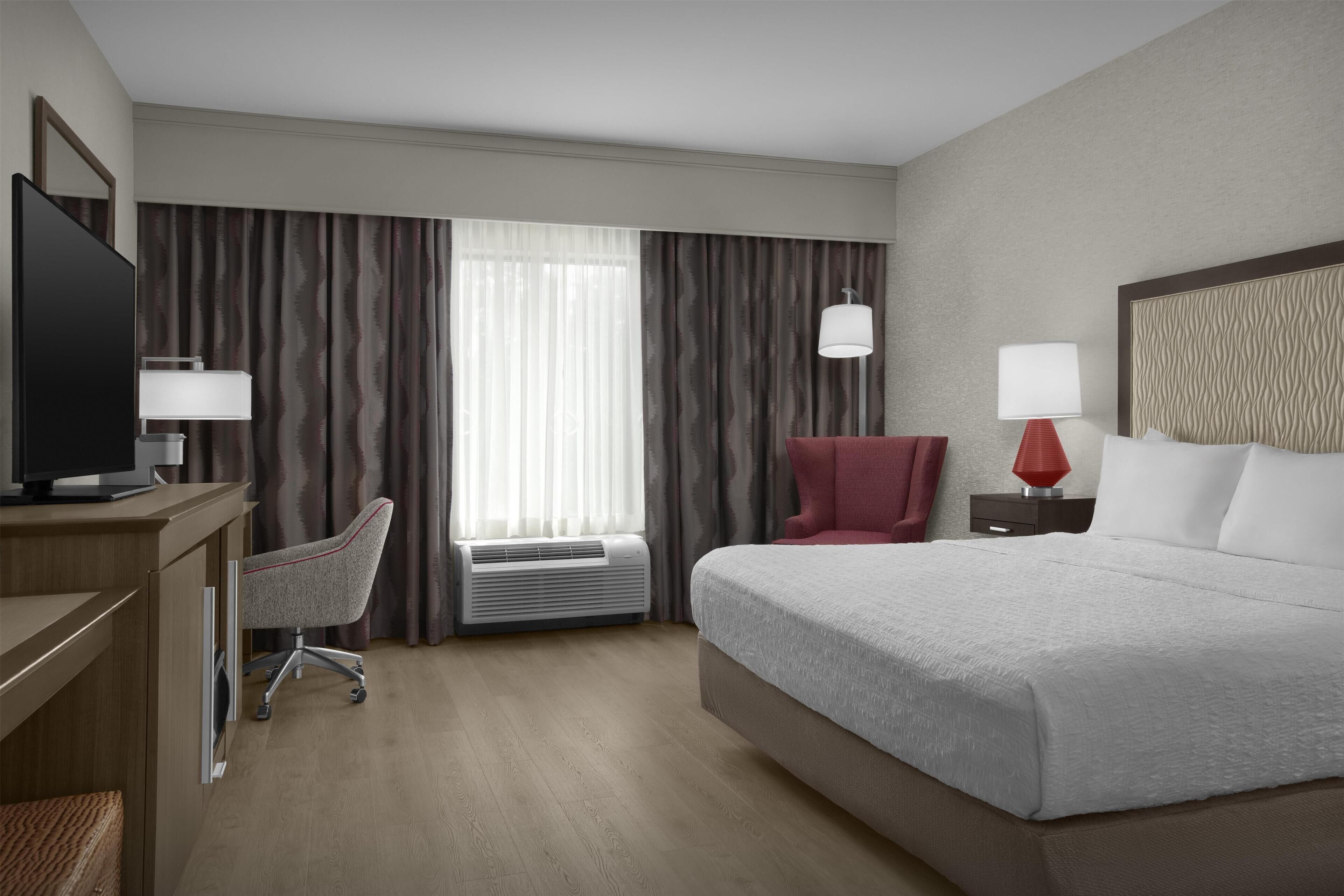 Premium bedding, desk, laptop workspace, blackout drapes