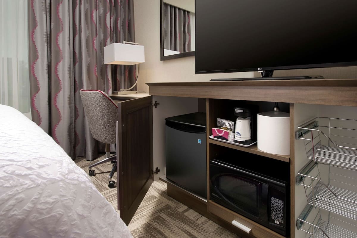 Premium bedding, desk, laptop workspace, blackout drapes