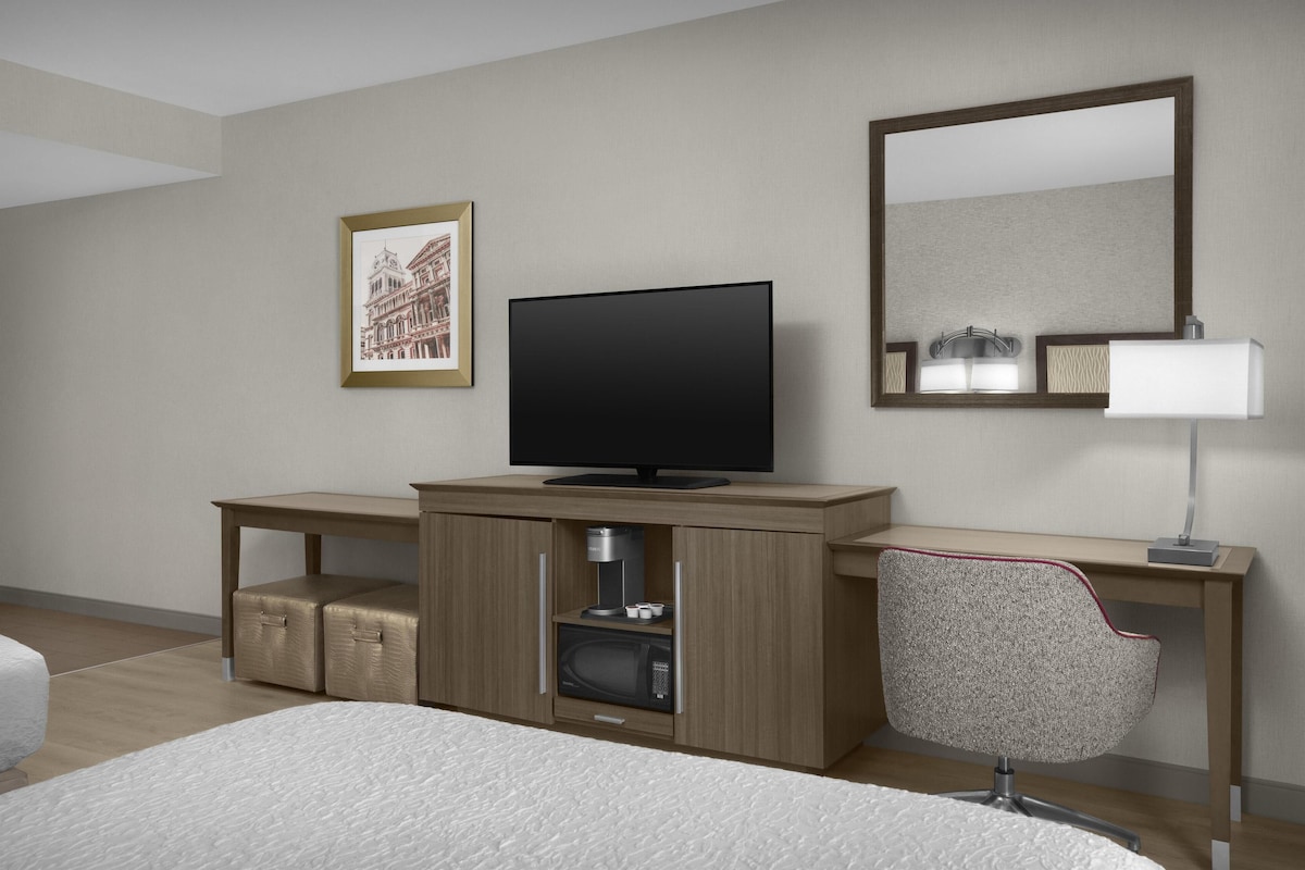 Premium bedding, desk, laptop workspace, blackout drapes