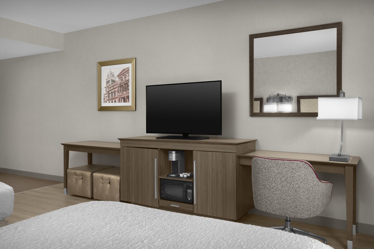 Premium bedding, desk, laptop workspace, blackout drapes