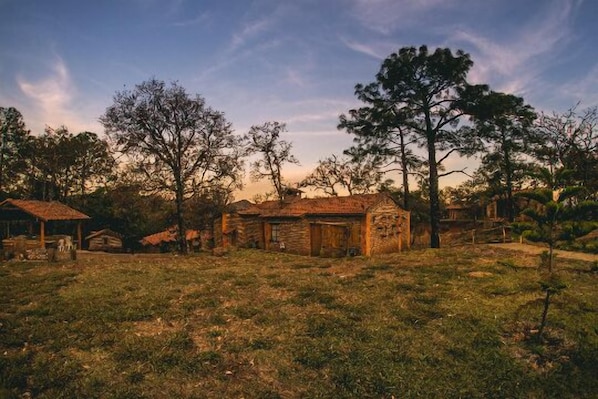 A rustic village with stone buildings and a grassy field. - Abba Eco Adventure (Concepcion de Buenos Aires)