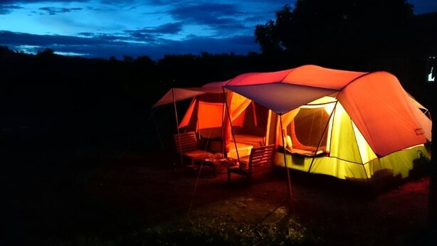 A tent with a table and chairs set up for outdoor dining.