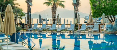 Outdoor pool, open 10 AM to 6:30 PM, pool umbrellas, pool loungers