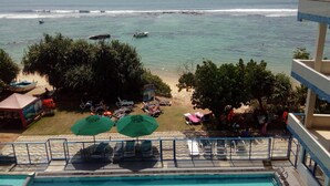 A poolside view with a beach and ocean in the background. - Paradise Beach Resort (Thalaramba)