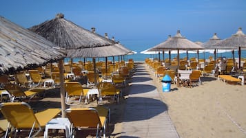 On the beach, sun loungers, beach umbrellas, beach towels
