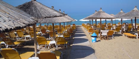 On the beach, sun-loungers, beach umbrellas, beach towels