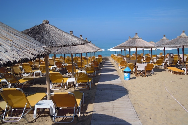 On the beach, sun loungers, beach umbrellas, beach towels